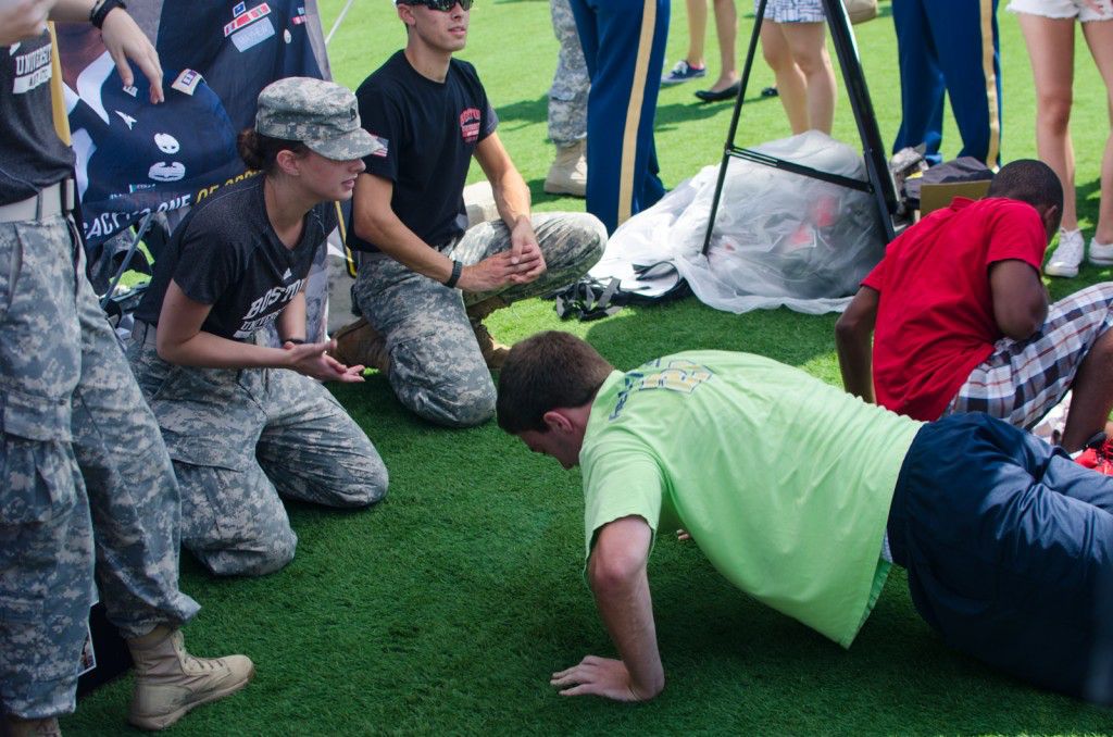 Students do push-ups to win prizes at the Army-ROTC tent. PHOTO BY MIKE DESOCIO/DAILY FREE PRESS STAFF
