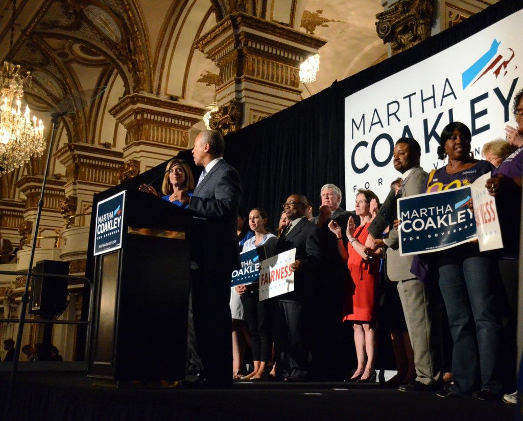 Supporters of Martha Coakley stand on stage as Massachusetts Deval Patrick speaks to the crowd. PHOTO BY FALON MORAN/DAILY FREE PRESS STAFF