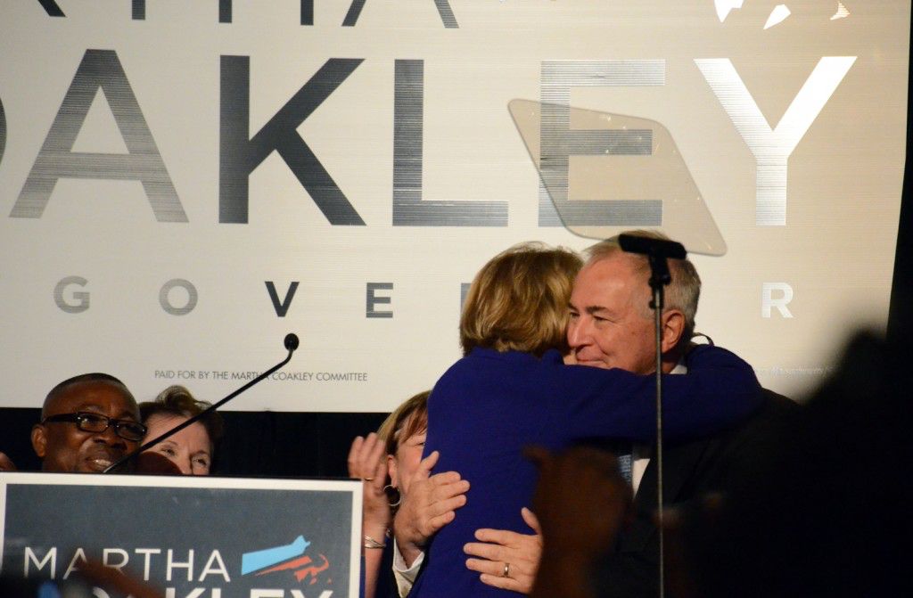 Martha Coakley hugs her husband on stage. PHOTO BY FALON MORAN/DAILY FREE PRESS STAFF