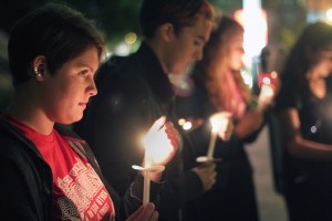 Danielle McFeah (CAS '16) holds a candle at the Interfaith Peace Vigil for the Middle East at Marsh Plaza Monday, where students from various faith groups came together to pray for peace, mourn loss and stand as a symbol of unity and compassion for the violence in Gaza and Israel. PHOTO BY SARAH SILBIGER/DAILY FREE PRESS CONTRIBUTOR