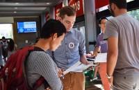 Jared Moffat, a field director for Regulate Mass, provides a student with information on voting at the voter registration drive hosted by the BU College Democrats Thursday in the George Sherman Union. PHOTO BY ELLEN CLOUSE/ DAILY FREE PRESS STAFF