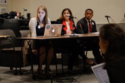 The BU Recharged candidate for Vice President, Laura Davis, a sophomore in the College of Communication; Anai Sanchez, candidate for VP of Internal Affairs and a junior in COM; and VP of Finance candidate Justin Flynn, a junior in the Questrom School of Business, wait for their turn to respond to questions at Thursday's 2016 Student Government Election Slate Debate. PHOTO BY SAVANAH MACDONALD/DAILY FREE PRESS STAFF