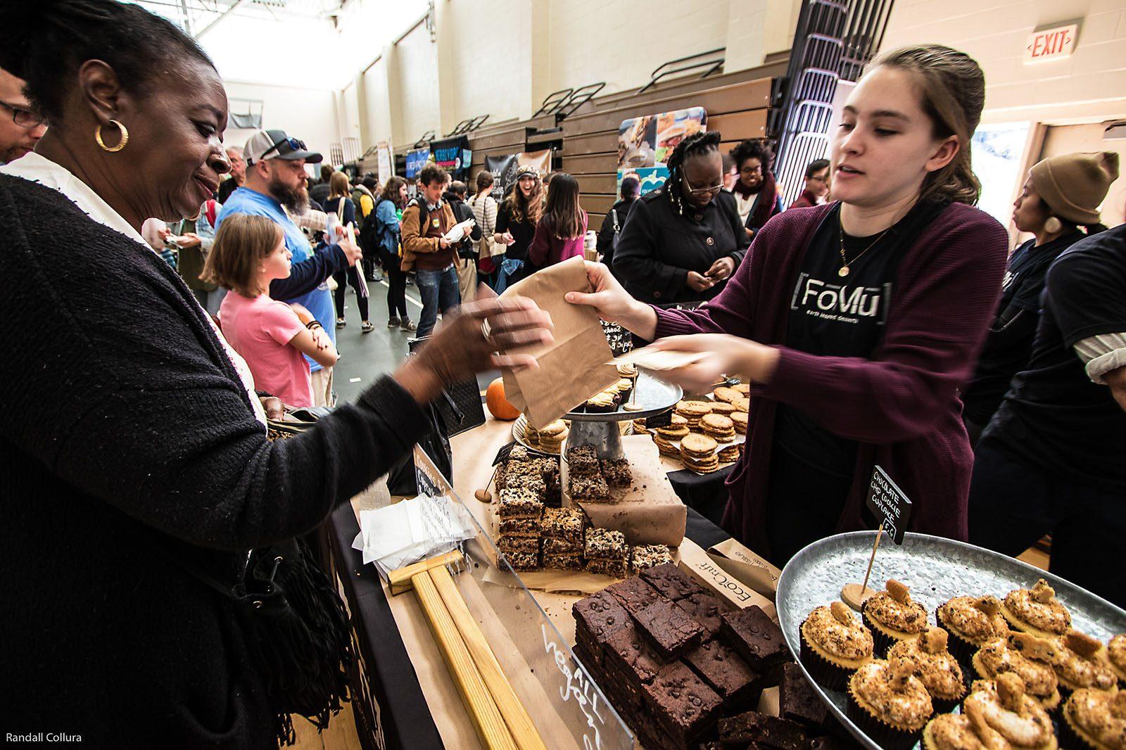 An attendee at the Boston Veg Food Fest stops by FoMu’s booth, a Massachusetts-based vegan ice cream company. The annual event was hosted this past weekend at the Reggie Lewis Athletic Center in Roxbury. COURTESY OF RANDALL COLLURA