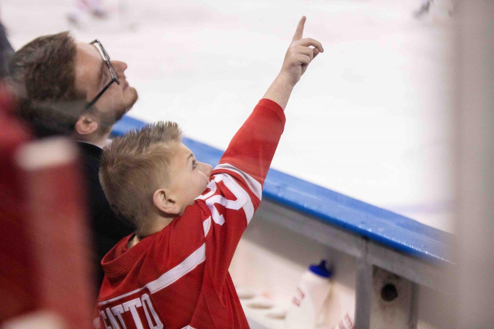 Boston University men’s ice hockey Team IMPACT teammate Logan Gatto points to himself on the jumbotron at Madison Square Garden Nov. 25, 2023. HOLLY GUSTAVSEN/DFP FILE