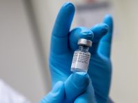 scientist holds a vial of the pfizer-biontech covid-19 vaccine