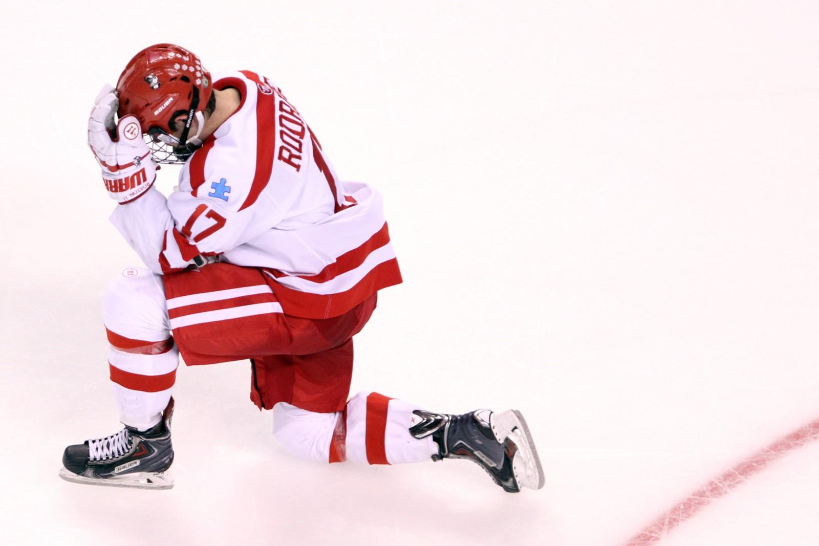 Evan Rodrigues kneels on the ice after his team's loss in the national championship game. PHOTO BY MAYA DEVEREAUX/DAILY FREE PRESS STAFF