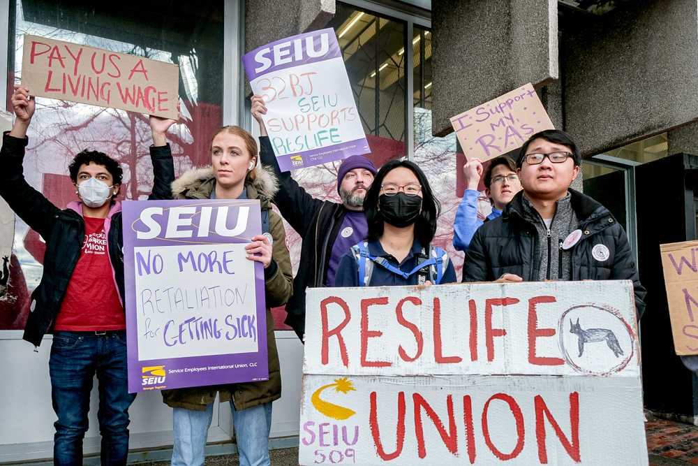 Protesters hold up signs for the Reslife Union Rally in front of George Sherman Union. ZIYU (JULIAN) ZHU/DFP STAFF