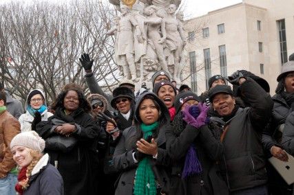 Spectators cheer along Constitution Avenue in Washington, D.C. as they listen to the swearing-in ceremony for President Barack Obama on the day of the 57th Presidential Inauguration. PHOTO BY BILLIE WEISS/BU NEWS SERVICE