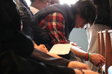 College of Engineering alumnus Tom Murphy, class of 2012, prays with a Rosary at the BU Catholic Center chapel in commemoration of Pope Benedict XVI's abdication Thursday. PHOTO BY MADISON FRANCOIS/DAILY FREE PRESS STAFF