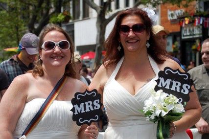 At least 30 Massachusetts businesses and companies are opposing the Defense of Marriage Act. Pictured here are two women during Pride 2012. PHOTO BY KARA KORAB/DAILY FREE PRESS FILE