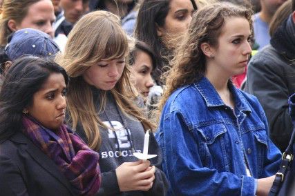 Students gather at Marsh Plaza Tuesday evening as a part of a candlelight vigil for the victims of the Boston Marathon explosions. PHOTO BY SARAH FISHER/DAILY FREE PRESS STAFF