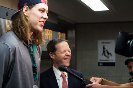 Boston Celtics first-round pick Kelly Olynyk and secretary of the Massachusetts Department of Transportation Richard A. Davey promote the newly built MBTA electronic message board Thursday at Kenmore station. These message boards inside Kenmore Station now tell passengers which Green Line train will arrive next. PHOTO BY KENSHIN OKUBO/DAILY FREE PRESS STAFF