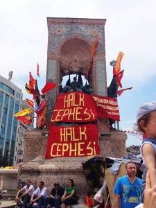 Protesters hold “The People’s Front” banners standing on the Monument of the Republic in Taksim Square, Istanbul during the protests in early June. PHOTO COURTESY OF NUMAN AKSOY.