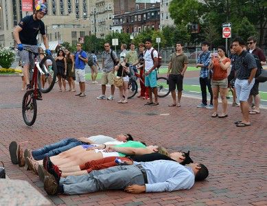 Red Bull Athlete Thomas Oehler jumps over several volunteers as other students look on Tuesday afternoon in front of Marsh Plaza. PHOTO BY HEATHER GOLDIN/DAILY FREE PRESS STAFF