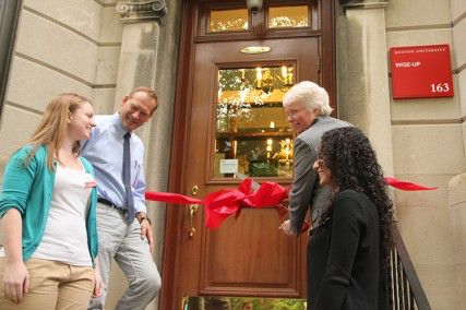 From left: Resident Assistant Kristal Sullivan, Physics Professor Benett Goldberg, University Provost Jean Morrison and Resident Assistant Iriny Ekladious cut the ribbon at the official opening of the WISE-UP speciality house Tuesday afternoon on Bay State Road. PHOTO BY SARAH SIEGEL/DAILY FREE PRESS STAFF