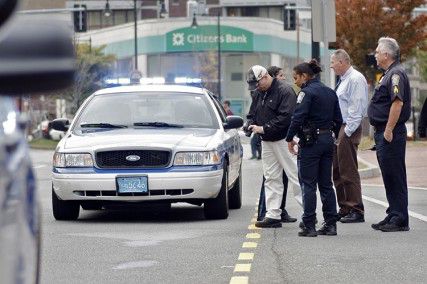 Police and officials stand by the location where an unaffiliated vehicle hit an 81 year old man jaywalking near the Brookline Ave. and Commonwealth Ave. intersection Tuesday afternoon. PHOTO BY SARAH FISHER/DAILY FREE PRESS STAFF 