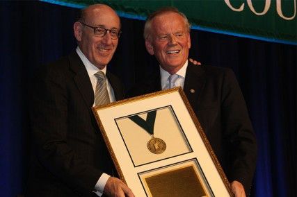 Kenneth R. Feinberg, Administrator of The One Fund Boston, receives the New Englander of the Year award from James Brett, President and CEO of The New England Council Wednesday night at the Seaport Hotel. PHOTO BY KIERA BLESSING/DAILY FREE PRESS STAFF