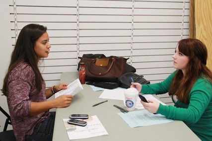Coloyan (left) speaks with Hilary Auker (right), who she recruited at orientation this summer. PHOTO BY DEBORAH WONG/DAILY FREE PRESS STAFF. 