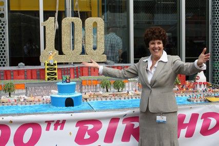 Carole Charnow, President and Chief Executive Officer of the Boston Children’s Museum, poses by the 1,200-pound cake at the Boston Children's Musuem Friday afternoon. PHOTO BY THANASI KASTRITIS/DAILY FREE PRESS CONTRIBUTOR 