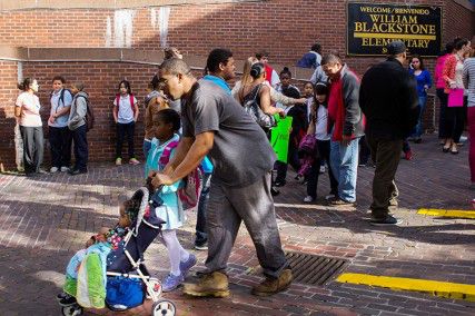 A parent leaves the William Blackstone Elementary school with two children as the school day ends. A surprise strike today by Boston Public School bus drivers affected more than 30,000 students, with many left stranded at their usual bus stops. PHOTO BY KENSHIN OKUBO/DAILY FREE PRESS STAFF 