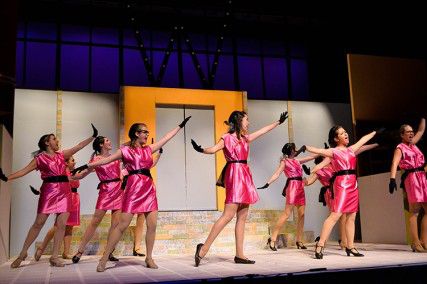Becky Ittner (Smitty), Mary Miller (Rosemary) and a female ensemble perform a dancing number in On Broadway’s “How to Succeed in Business.”  PHOTO BY HALEY SKOV/DAILY FREE PRESS STAFF. 