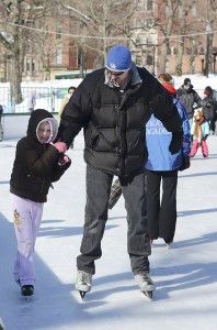 Brian Murray, who is currently serves at the Hanscom Air Force Base in Bedford, skates with his daughter Clara Monday morning at Boston Frog Pond during a military family event hosted by the Home Base Program. PHOTO BY MIKE DESOCIO/DAILY FREE PRESS STAFF