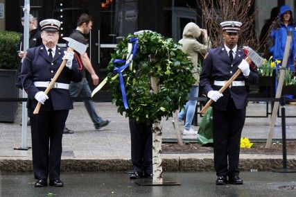 Officers stand on Boylston Street Tuesday with a wreath to honor those affected by the 2013 Boston Marathon bombings on the anniversary. A tribute was held later that day with distinguished guests and members of the community. PHOTO BY FELICIA GANS/DAILY FREE PRESS STAFF