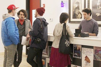 ALEX HENSEL/DAILY FREE PRESS STAFF ARCH manager Nick Grieco (with bandana) talks with guests at the Allston Rock City Hall gallery opening Saturday before it was shut down.