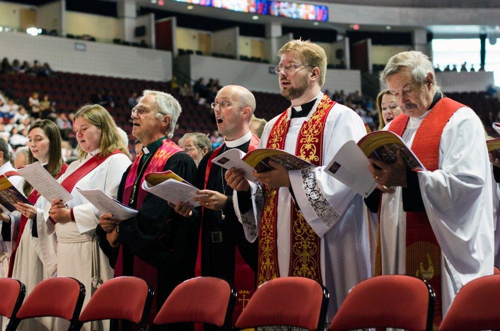 Attendees sing during the Saturday ceremony at Agganis Arena where the Episcopal Dioceses of Massachusetts elected Rev. Alan M. Gates as its new bishop. PHOTO BY MIKE DESOCIO/DAILY FREE PRESS STAFF