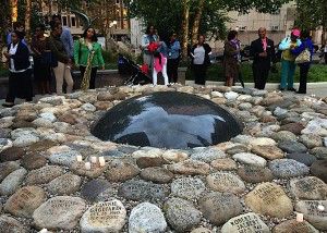 Attendees pay tribute to homicide victims at the Garden of Peace memorial Thursday. PHOTO BY JAIME BENNIS/DAILY FREE PRESS STAFF