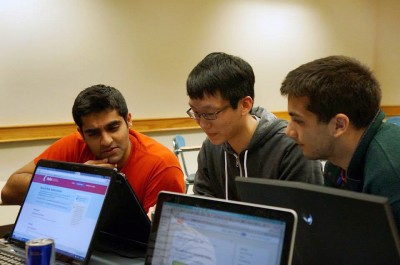 Boston University College of Engineering seniors Kanav Dhir, Alex Wong and Deven Dayal create the Bzzy website at the Make_BU Hackathon in March. PHOTO COURTESY OF KANAV DHIR