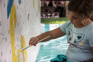 Emma Carroll, 6, of Cazenovia, New York, paints at the “Paint-By-Goya” interactive mural project in Copley Square Saturday, which was sponsored by Santander Bank and the Museum of Fine Arts. PHOTO BY ALEXANDRA WIMLEY/DAILY FREE PRESS STAFF