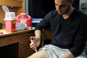 Graham Brunell (SMG ‘18) administers his own medication for his Crohn’s disease because he currently does not have access to medical marijuana. PHOTO BY SARAH SILBIGER/DAILY FREE PRESS CONTRIBUTOR