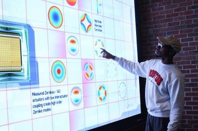 Jordan Carter (CFA ‘17) interacts with the recently installed collaboration video wall at Boston University’s College of Engineering, which highlights ongoing research at the college. PHOTO BY MAE DAVIS/DAILY FREE PRESS STAFF