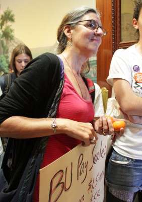 Boston University adjunct professor Maureen Sullivan symbolically offers her dinner to BU President Robert Brown during a BU workers march in October. The National Labor Relations Board set a January date for BU adjunct professors to vote on whether they will unionize and be represented by the Service Employees International Union. PHOTO BY FELICIA GANS/DFP FILE PHOTO