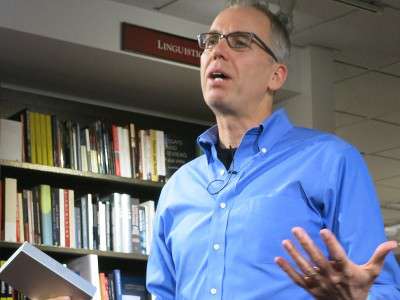 Frank Warren, founder of online community art project PostSecret, gives a presentation as part of a "PostSecret Live" event at the Harvard Cooperative Society on Nov. 3. PHOTO BY NAVRAJ NARULA/DAILY FREE PRESS STAFF