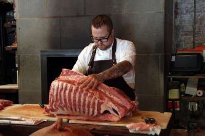 Boston-based chef Jamie Bissonnette, seen here preparing pork ribs, praises the inclusiveness of the Boston culinary scene, as showcased on the current season of TV show "Top Chef." PHOTO COURTESY OF BREVILLE USA