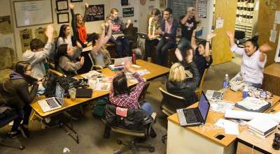 The Daily Free Press staff celebrates Wednesday upon hearing news that the publication surpassed its fundraising goal of $70,000. PHOTO BY ALEXANDRA WIMLEY/DAILY FREE PRESS STAFF