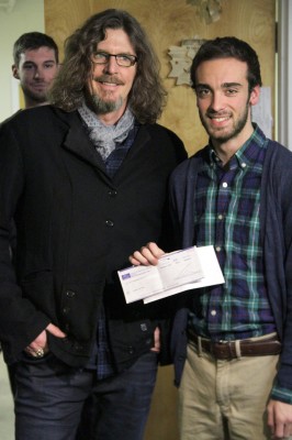 Boch presents Plantz with a check for $50,000, which he donated after the Daily Free Press announced that it was in debt. PHOTO BY SARAH SILBIGER/DAILY FREE PRESS STAFF