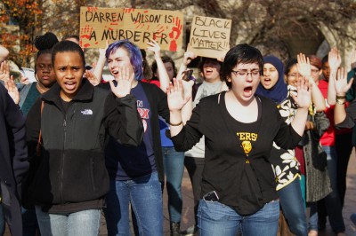 Boston University students chanted phrases such as "Hands Up! Don't Shoot!" during the #HandsUpWalkOut demonstration at Marsh Plaza Monday. PHOTO BY SARAH SILBIGER/DAILY FREE PRESS STAFF