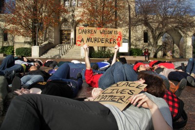 Student demonstrators participated in a "die-in" where they laid still in Marsh Plaza for four and a half minutes to symbolize the four and a half hours Michael Brown laid in the street after being shot. PHOTO BY SARAH SILBIGER/DAILY FREE PRESS STAFF