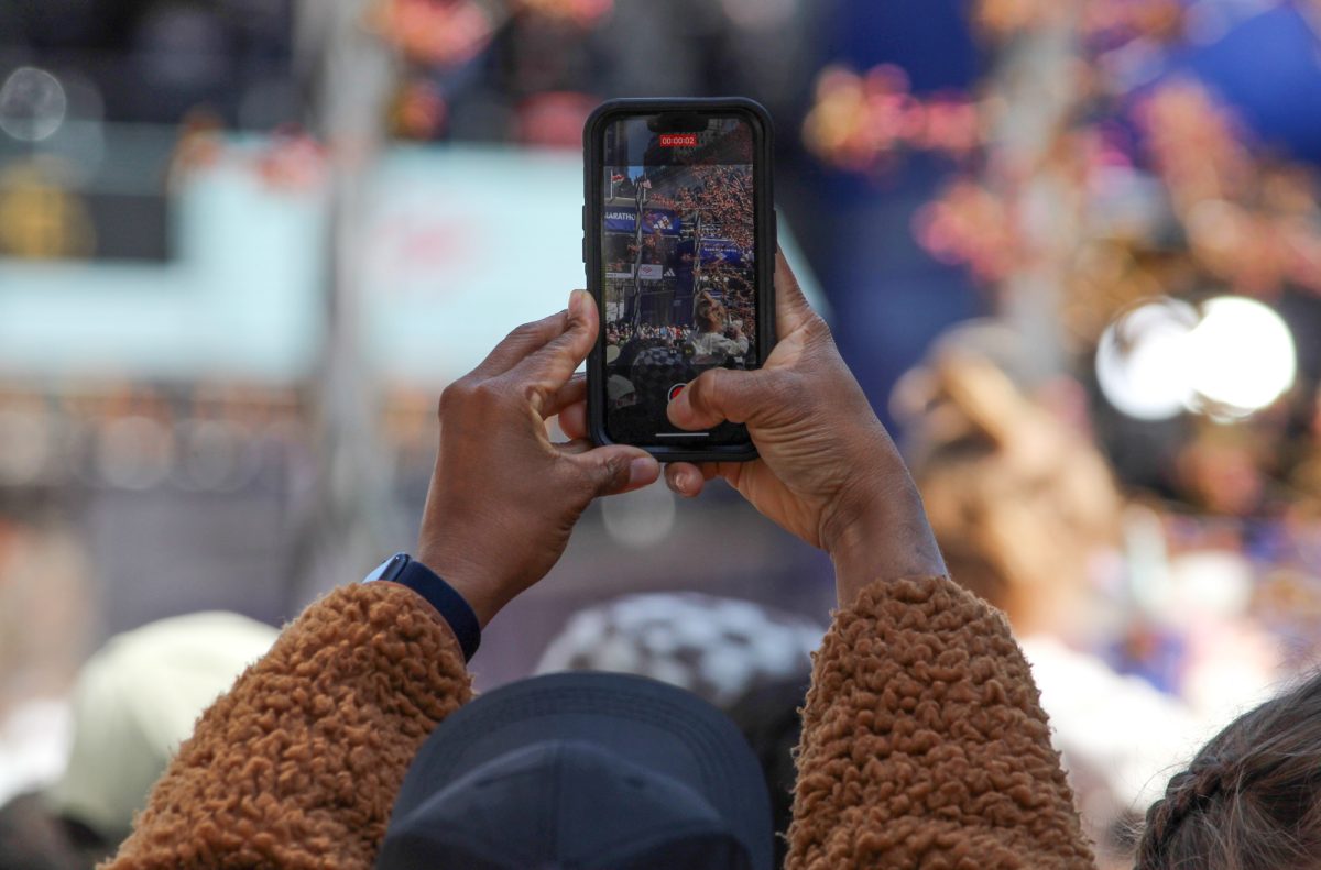 A fan records the marathon on Monday. 