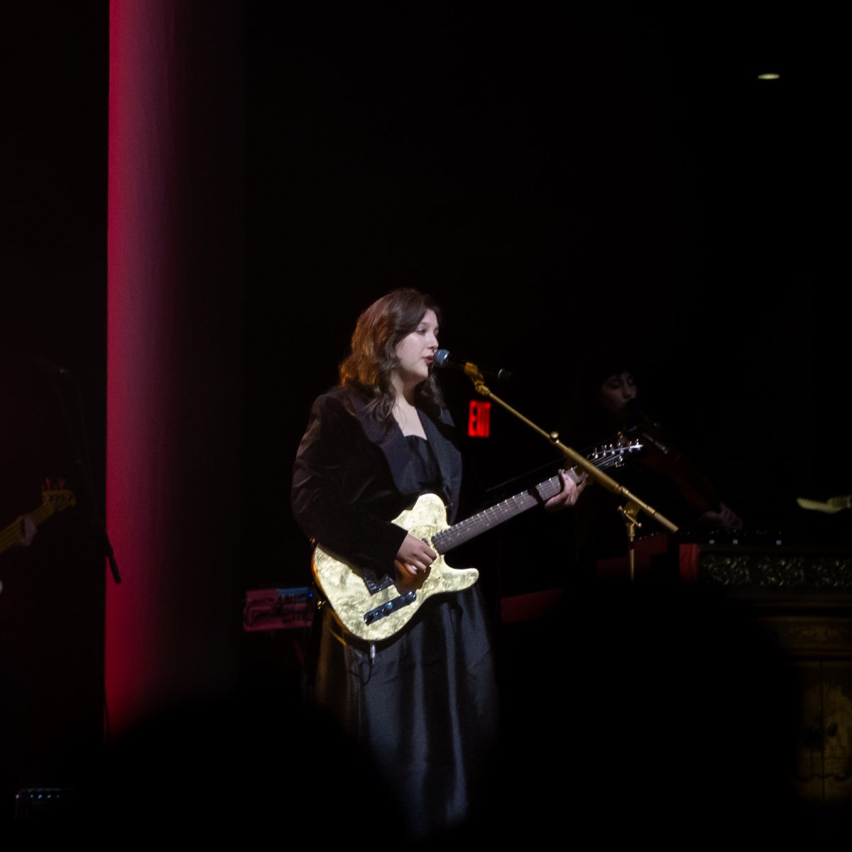 Lucy Dacus singing and playing the guitar Sunday. 