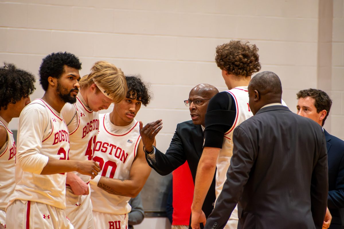 Men’s basketball coach Joe Jones huddles up with players during a game in February. Jones, who is entering his fifteenth year as head coach, shared his excitement about the team’s participation in the Naismith Basketball Hall of Fame Showcase against Harvard University Nov. 22. 
