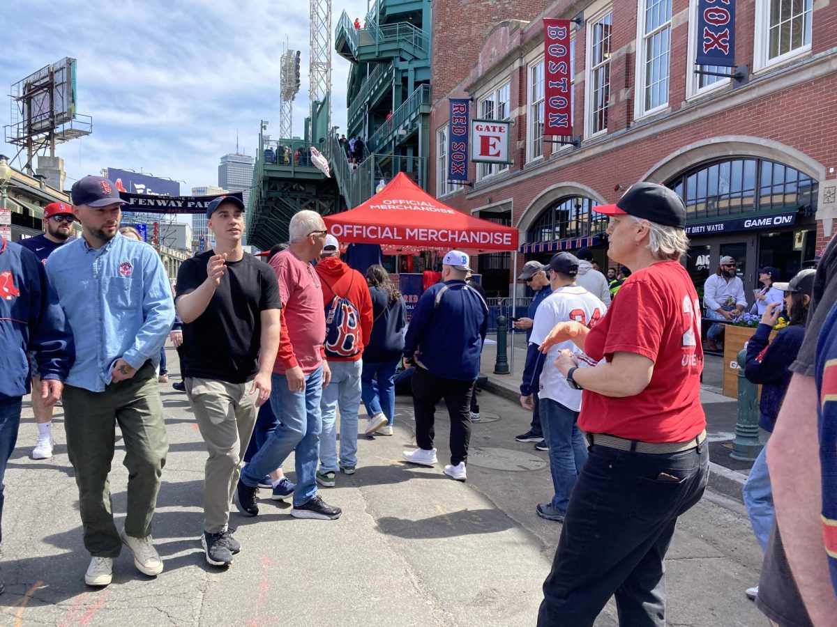 Fenway Park workers distribute packets of peanuts outside the ballpark before the game on Fenway Opening Day April 4. More than 1,000 UNITE HERE Local 26 union workers employed at MGM Music Hall and Fenway Park will vote from June 13 to 15 to authorize the first concessions workers’ strike in Fenway history. 