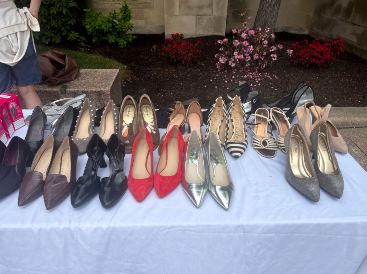 High heels including strappy, stiletto and platform lined up on the table in front of Boston University’s Marsh Chapel. BU Student Government’s Sexual Assault Prevention department’s Walk a Mile in Her Shoes event, where male-identifying students walked a mile in high heels to spread awareness of sexual violence against women. 