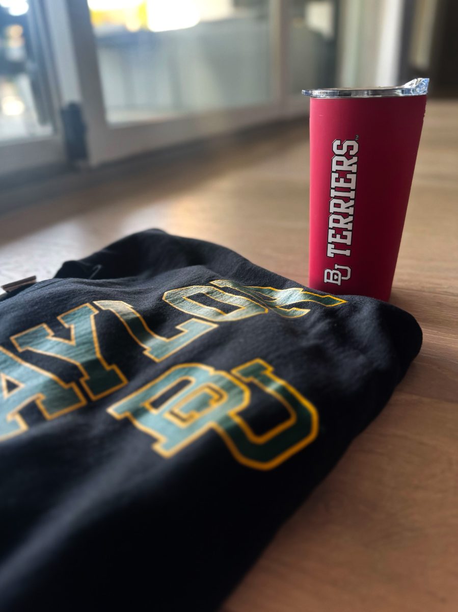 A Baylor University sweatshirt and a Boston University cup, both depicting an interlocking “BU” logo. Baylor University sued Boston University over the “essentially identical” logo. 