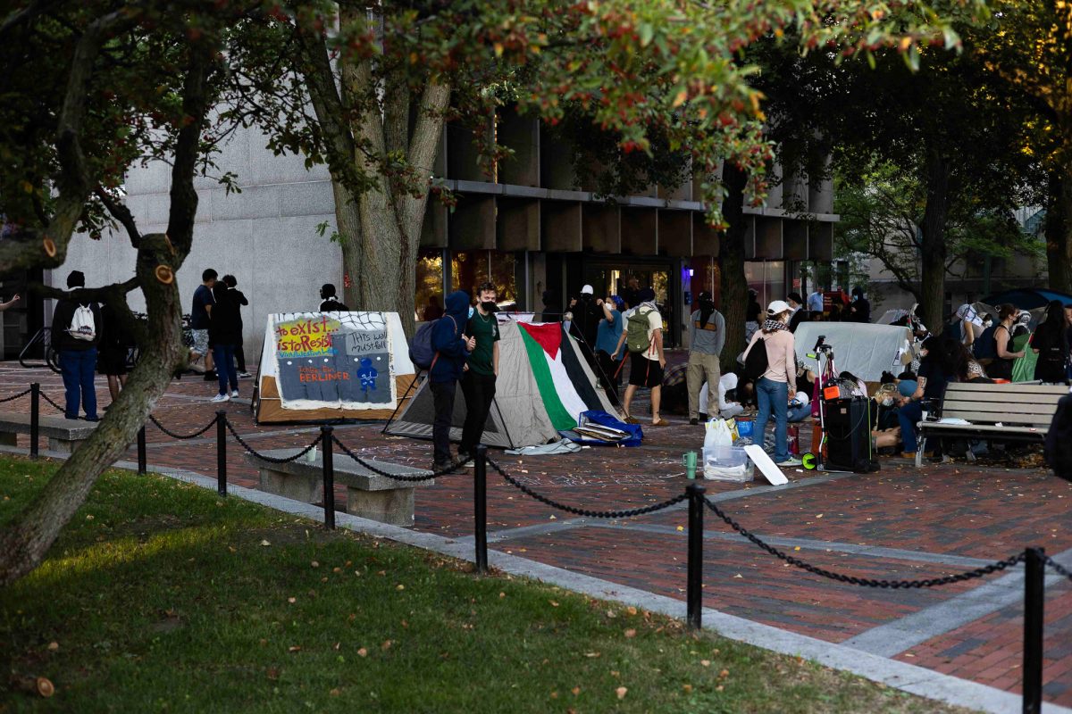 Protesters gather and set up tents in front of the George Sherman Union at Boston University. The protesters continued to accumulate throughout the evening gathering a large police presence.