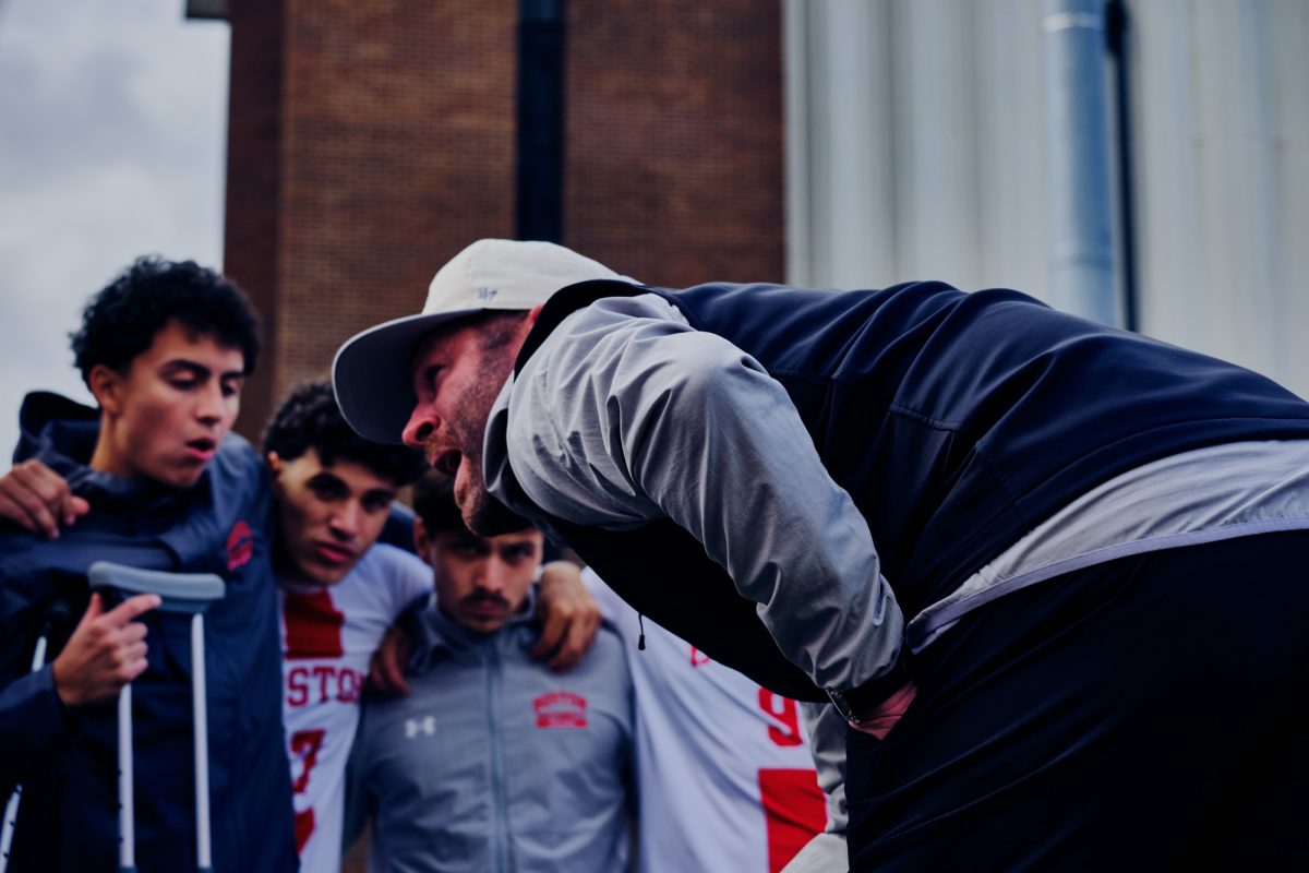 Boston University Men’s Soccer Head Coach Kevin Nylen speaks to the team during a huddle.