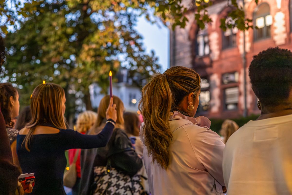 Mourners hold up purple candles to honor the individuals who lost their lives to domestic violence in Massachusetts over the last year. The vigil was organized by the city of Cambridge in collaboration with domestic abuse treatment center Transition House and included several resources for survivors and guest speakers. 